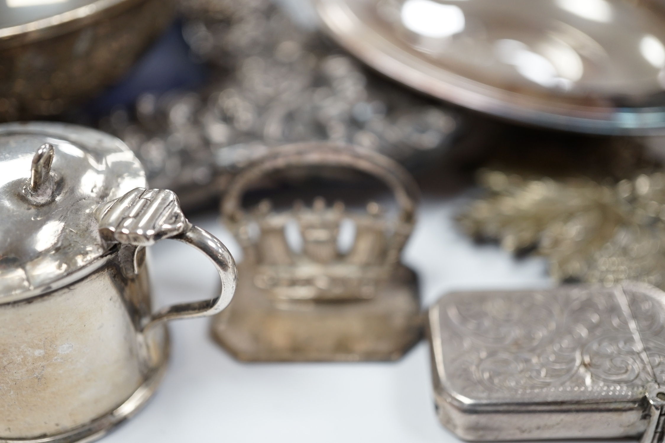 A quantity of silver items including a late Victorian repousse photograph frame, William Comyns, London, 1899, 20cm, three Georgian pepperettes, pair of small Armada dishes, quaich, vest case, menu holder, basting spoons